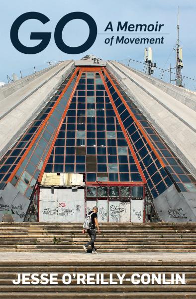 A book cover with a photo of a large triangular building, covered in graffiti. There is a man standing in front of it, but he looks small because the photo was taken from far away.